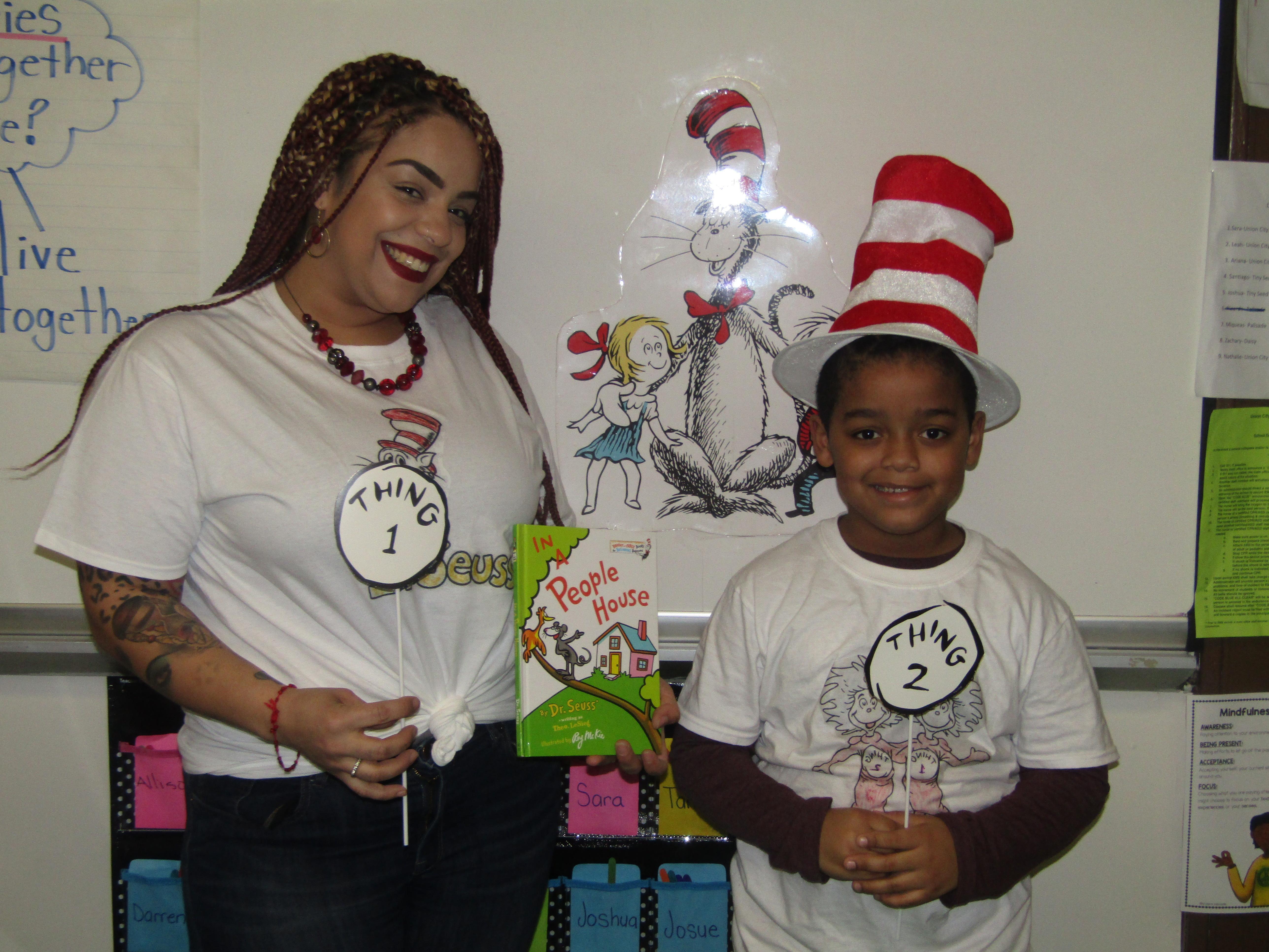 proud mom and son wearing matching things 1 & 2 shirts holding dr. seuss book