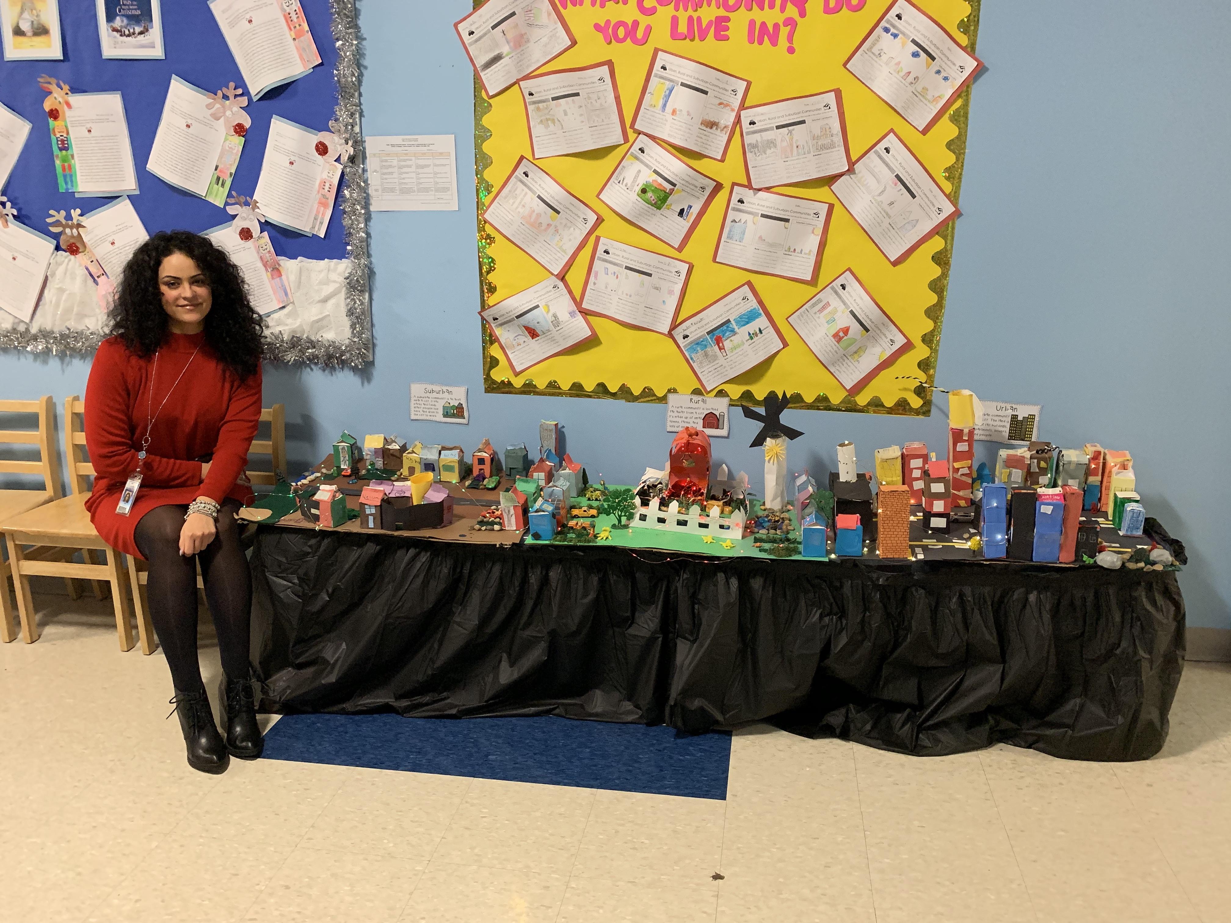 Ms. Hernandez with her class' city diorama