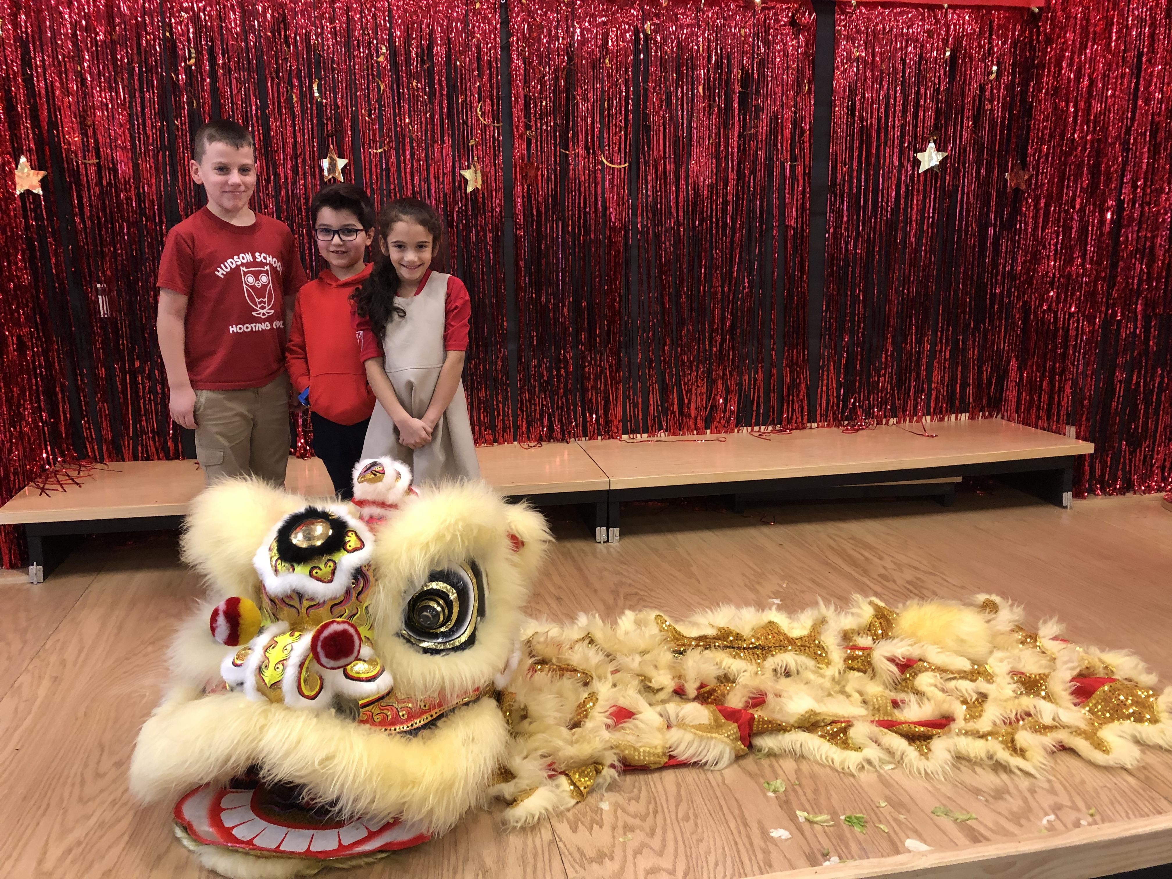 three students with the yellow dragon