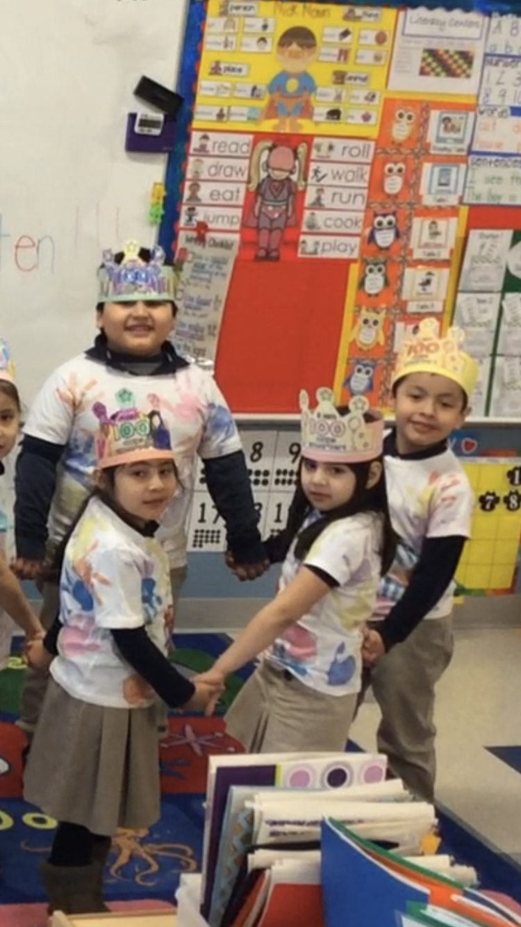 group of kids wearing crowns and holding hands in a circle
