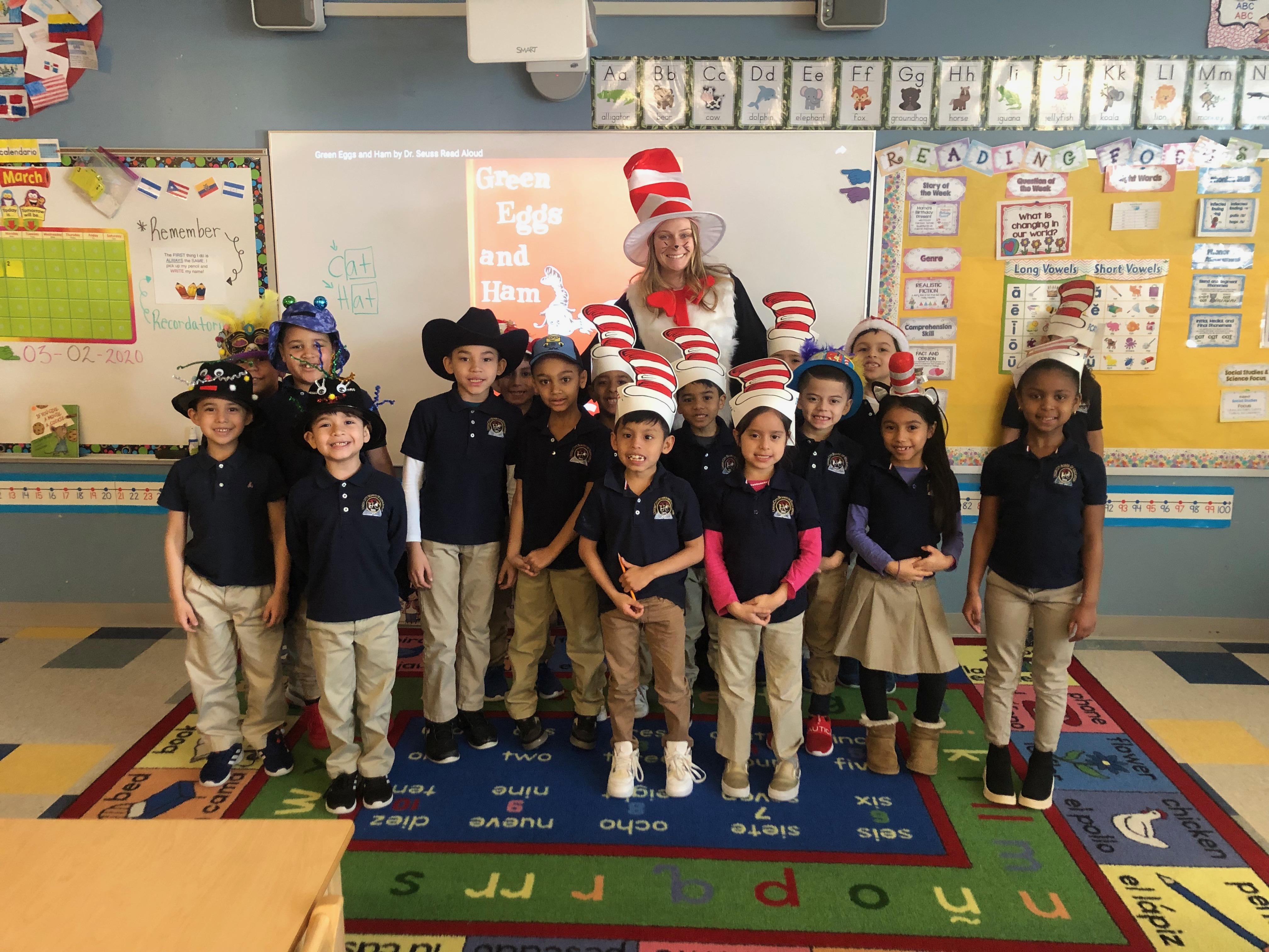 kindergarten teacher dressed as the Cat in the hat with her students wearing wacky hats